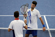 Novak Djokovic of Serbia is congratulated by Roberto Bautista Agut of Spain after their semifinal match during the Western & Southern Open at the USTA Billie Jean King National Tennis Center on August 28, 2020 in the Queens borough of New York City. 