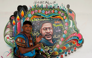 Pakistani truck painter Haider Ali, 40, next to his George Floyd mural in Karachi on June 12.
