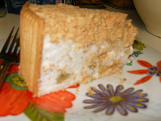 Slice of Grandma Rodocker's Old Fashioned Ice Box Cake. When sliced the crumbs follow the knife and cling to the cake.