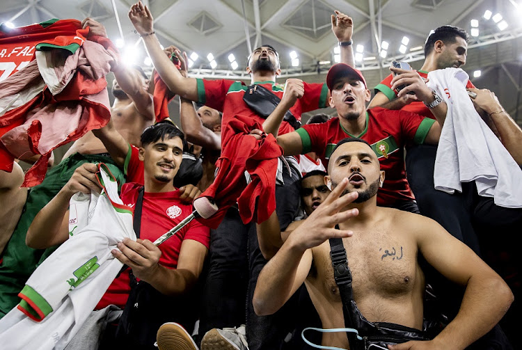 Moroccan supporters celebrate their victory against Portugal in the World Cup quarterfinal at Al Thumama Stadium in Doha, Qatar on December 10 2022.