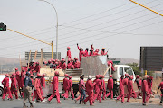 FILE PHOTO: Members of the red ants make their way through Lenasia, South of Johannesburg, after evicting residents. Members of the police have confirmed the death of two residents during clashes with the red ants on 23/09/2017