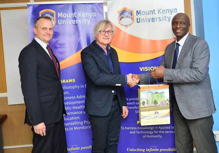 Mount Kenya University vice- chancellor. prof. Deogratius Jaganyi (right) presents a token of appreciation to Prof.Dr. Christian Lebrenz, Vice Dean of Faculty of Business (centre) and Prof. Dr. Stephan Bundschuh, Managing Director of the Institute of Social Sciences Research and Continuing Education from Hochschule Koblenz University of Applied Sciences, Germany. Officials from Hochschule Koblenz University had paid a courtesy call to the MKU Main Campus in Thika. The university will support MKU Heath care students visiting Germany integrate into the training and working environment in German hospitals as well as organise mentors and buddies to accompany them during their stay in the country.