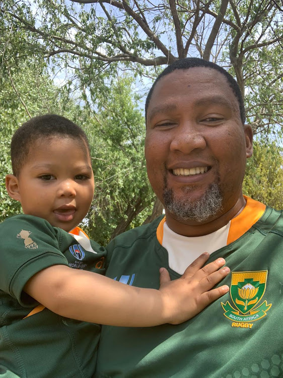 Nelson Mandela's grandson Mandla Mandela and his son Mandela wearing Boks jerseys in support of Springboks.