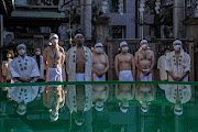 .Participants prepare to take part in an ice-bathing ceremony  during the annual new year Shinto ritual to purify the body and soul at Teppozu Inari Shinto Shrine on January 9, 2022 in Tokyo, Japan. This years ceremony was scaled back and closed to the general public as a precaution against Covid-19.  