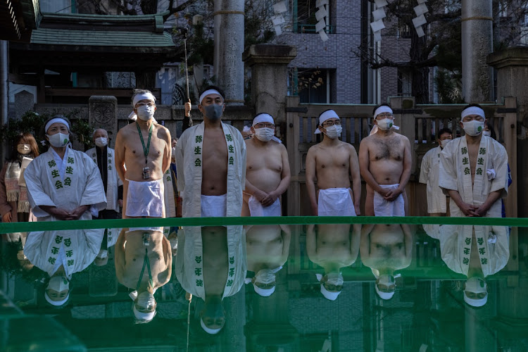 .Participants prepare to take part in an ice-bathing ceremony during the annual new year Shinto ritual to purify the body and soul at Teppozu Inari Shinto Shrine on January 9, 2022 in Tokyo, Japan. This years ceremony was scaled back and closed to the general public as a precaution against Covid-19.