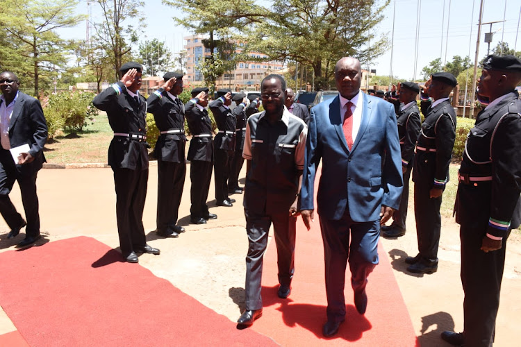 Busia Governor Sospeter Ojaamong and his Kisumu counterpart Anyang’ Nyong’o inspect a parade mounted byc ounty enforcement officers on Wednesday, March 20, 2019