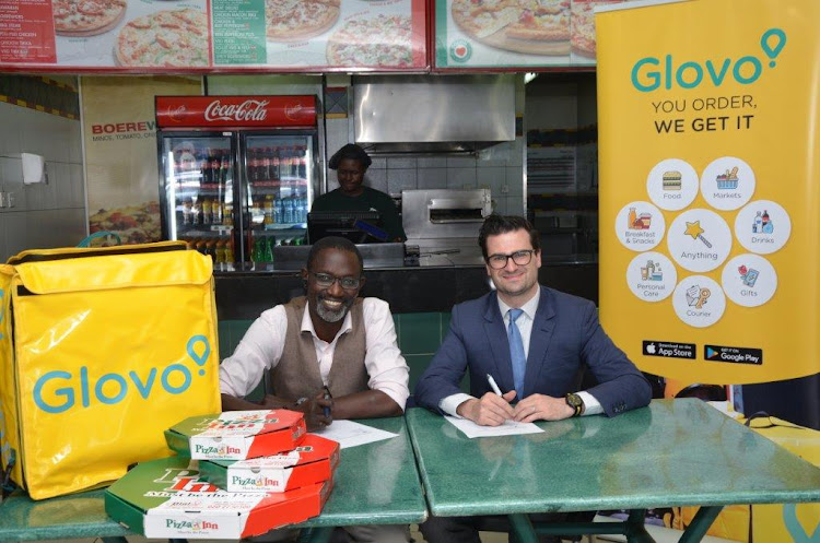 Simbisa brands head of business development Joseph Claver and Glovo's general manager for Kenya, William Benthall during the signing of a partnership/Courtesy