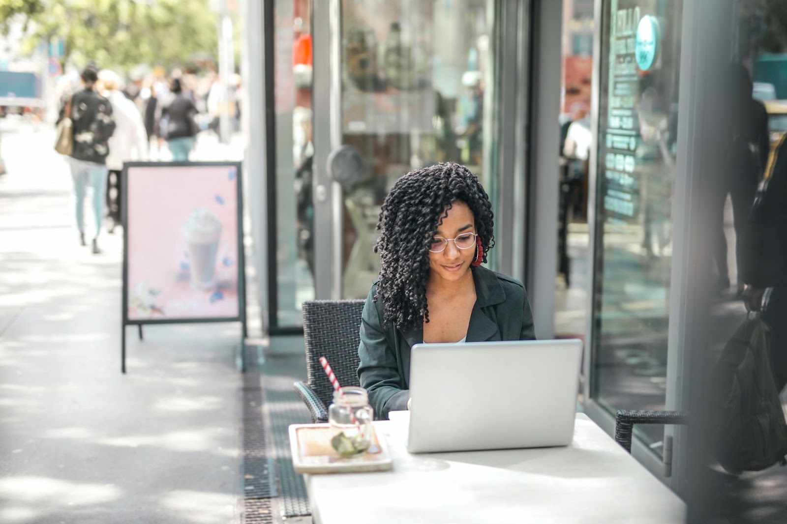 an animator who is working in the career of animation  outside using her laptop