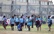 Pupils stand on the field at the Blomvlei Primary in Hanover Park. 