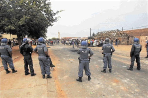 STANDOFF: Ratanda township residents continued to protest in the streets yesterday as police monitored them closely. PHOTO: VELI NHLAPO