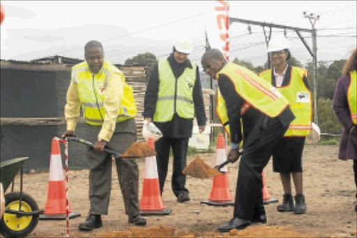 SPADE JOB: Transnet boss Brian Molefe and Public Enterprises official Siyabonga Mahlangu turn the sod at OR informal settlement in Western Cape. PHOTO: SABELO MPANA