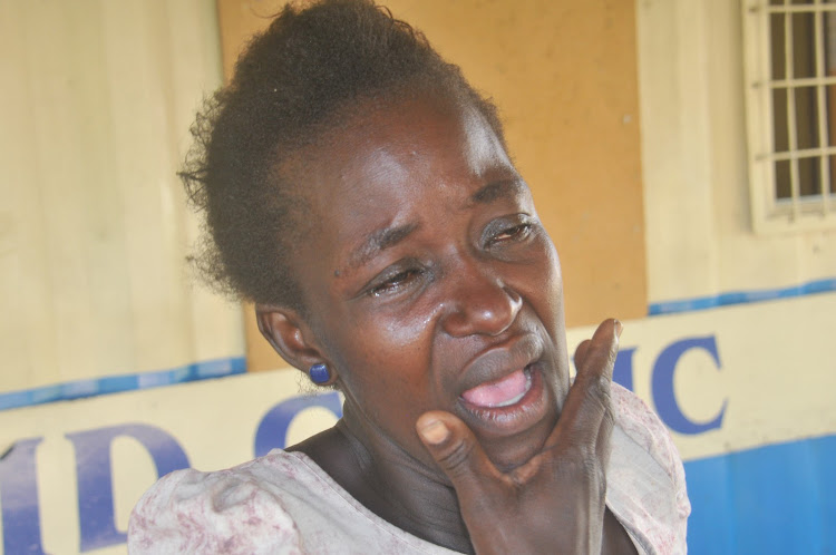 Florence Aluoch, the mother of 11-year- old Vincent Odunge, breaks down in tears while explaining the pain his son endured after allegedly being forced to drink acid by neighbours in Magongo.