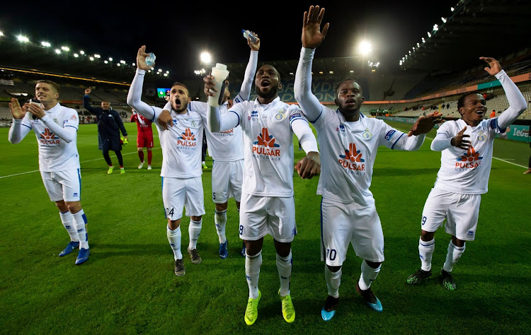 Percy Tau (far right) celebrates with teammates.