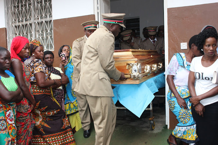 Administration officers remove a casket containing the remains of their college from a private mortuary in Malindi on October 7th 2018