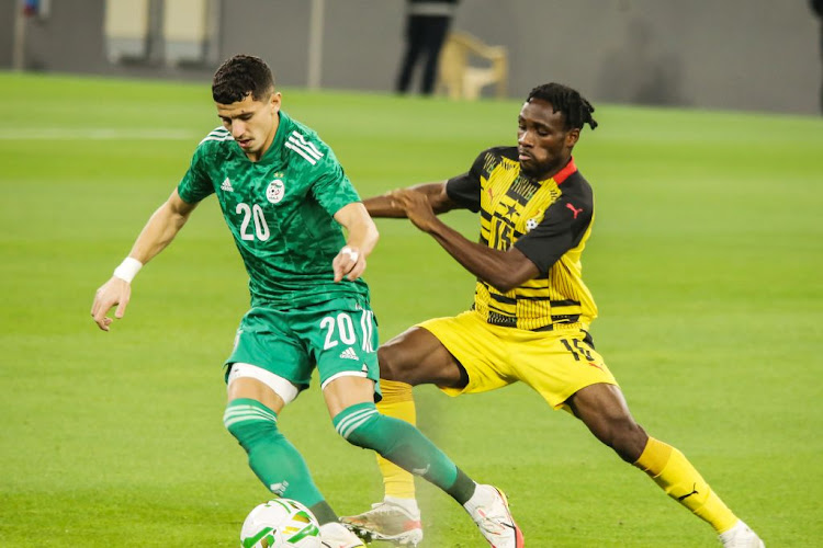 Joseph Paintsil of Ghana and Youcef Atal of Algeria during the friendly match between Algeria and Ghana ahead of the 2021 Africa Cup of Nations at Education City Stadium on January 05, 2022 in Al Rayyan, Qatar.