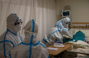 Medical workers treat a patient suffering from the coronavirus disease (Covid-19), at the Intensive Care Unit (ICU) of the Max Smart Super Speciality Hospital in New Delhi, India, September 5, 2020. 