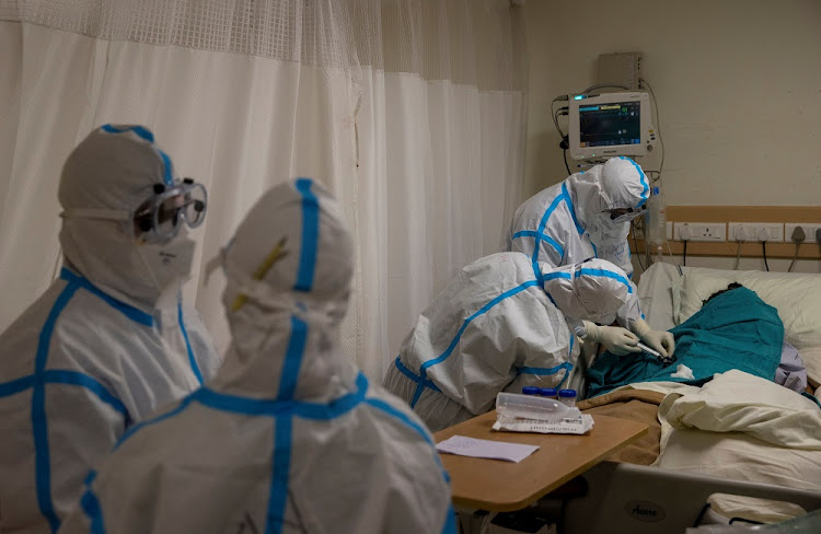 Medical workers treat a patient suffering from Covid-19, at the Intensive Care Unit (ICU) of the Max Smart Super Speciality Hospital in New Delhi, India, on September 5, 2020.