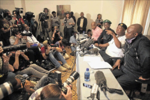 TALK: Julius Malema speaks after he was barred from meeting with striking Marikana miners. With him are Anda Bici, suspended ANC Youth League secretary general Sindiso Magaqa and spokesman Floyd Shivambu. PHOTO: VELI NHLAPO.