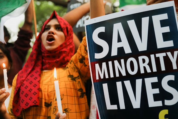 A view of a placard as citizens shout slogans during a peace vigil organised by citizens against what they say is rise in hate crimes and violence against Muslims in the country, in New Delhi, India, April 16, 2022.