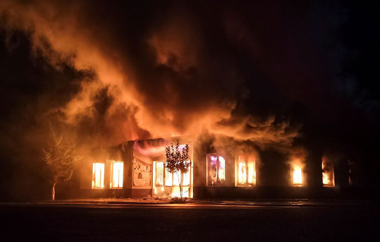 A shop is seen on fire following recent shelling during a military conflict over the breakaway region of Nagorno-Karabakh in Stepanakert on October 3 2020.