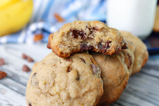 Chewy banana chocolate chip cookies with a glass of milk.