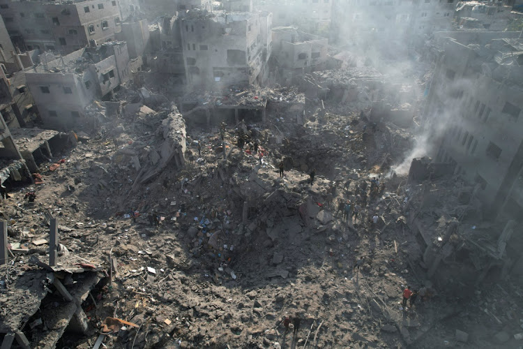 Palestinians gather at the site of Israeli strikes on houses in Bureij in the central Gaza Strip on November 2 2023. Picture: REUTERS/Mohammed Fayq Abu Mostafa