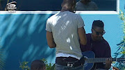 Big Brother housemates, Adams (playing the guitar) and K2.