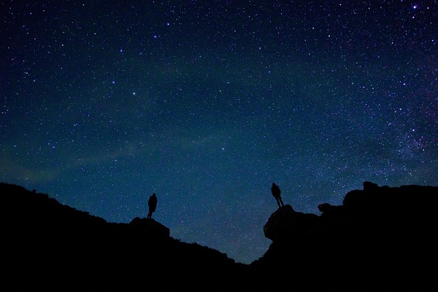 friends stargazing in camp at night - things to do while camping with friends