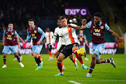 Luton Town's Ross Barkley and Burnley's Lyle Foster battle for the ball during their Premier League at Turf Moor.