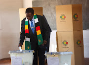 Zimbabwean President and leader of the ruling ZANU-PF, Emmerson Mnangagwa, gestures as he casts his vote in the general elections at the Sherwood primary school in Kwekwe, Zimbabwe, August 23, 2023.