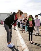 Rachel Kolisi pauses to speak to children waiting in line for food parcels.  She and Siya have helped people in the Western Cape, Eastern Cape, Limpopo and the Free State.