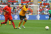 Shane McGregor ( r) beats John Barnes during the Legends match between Liverpool FC Legends and Kaizer Chiefs Legends at Moses Mabhida Stadium on November 16, 2013 in Durban.