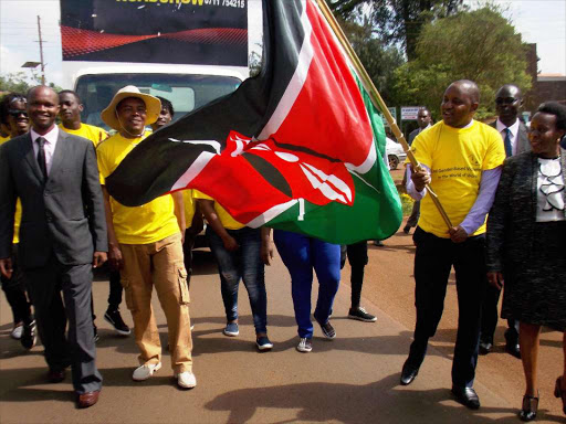 Embu deputy governor David Kariuki, accompanied by Gender executive Dr Joan Mwende, frags off participants who will take part in a fifteen days anti-gender violence campaign yesterday.