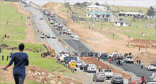 NO GETTING THROUGH: Mputhi Primary School pupils and residents of Mputhi village near Mthatha blockade the R61 road between Mthatha and Ngcobo, demanding the immediate appointment of a school principal Picture: LULAMILE FENI