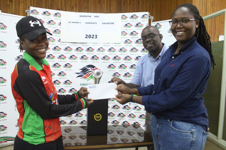 Queentor Abel receives her award from Cricket Kenya CEO Ronald Bukusi and Pearlyn Omamo at Cricket Kenya offices in Nairobi on March 27, 2024