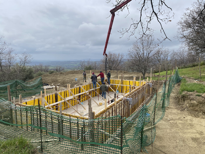 Constructing Santa Pia swimming pool, workman waiting to pour the concrete