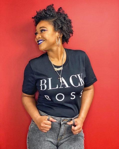 African American woman smiling wearing "Black Boss" t-shirt