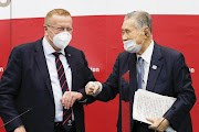 Chairman of the Tokyo 2020 Olympic Games co-ordination committee John Coates (L) and Tokyo 2020 president Mori Yoshiro bump elbows.