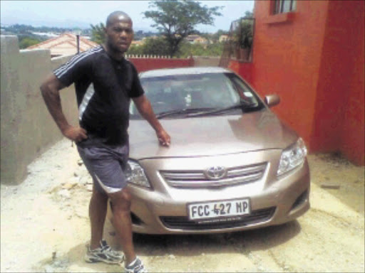 A WRITE-OFF: Jones Mashego, Mathebula's fiancé, standing next to their car before they discovered it had previously been written off.