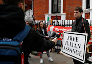 A supporter of WikiLeaks founder Julian Assange talks to the media, after Assange was arrested by British police, outside the Ecuadorian embassy in London, Britain, April 11, 2019.