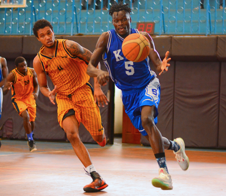 KPA's Ariel Okall (R) charges past Larry Davey of USIU in a past match