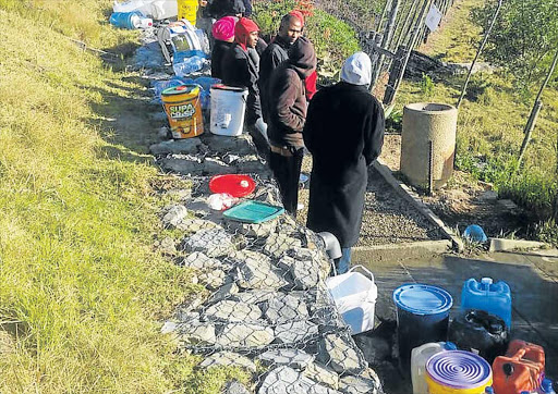 WATER WOES: Grahamstown residents queue for water at the spring yesterday Picture: DAVID MCGREGOR