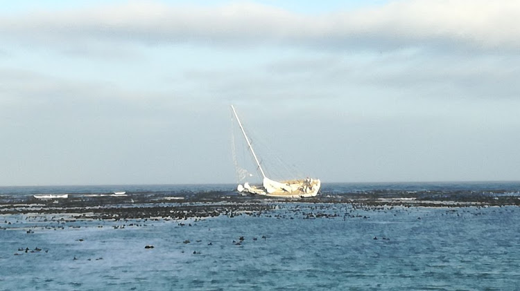 The crew of the CV24 Greenings were evacuated as a precautionary measure when their boat hit a rocky area near Cape Point.