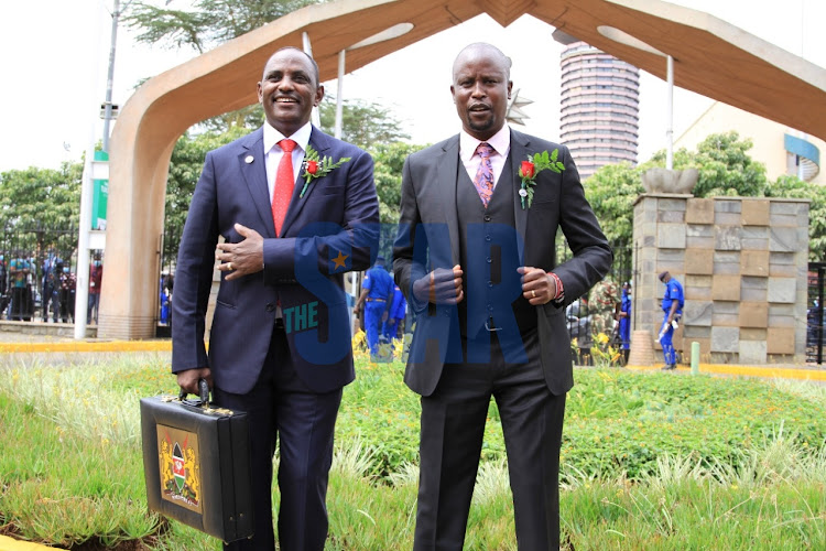 Treasury CS Ukur Yatani poses for a photo with Budget and Appropriations committee chairman Kanini Kega on June10/