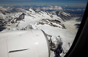 Lufthansa unit Swiss International Air Lines new Bombardier CS100 aircraft flies past the Jungfraujoch and the Aletsch Glacier (R) during a flight over the Swiss Alps, Switzerland July 6, 2016. 