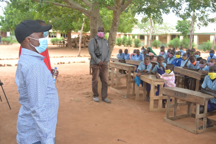 Ganze MP Teddy Mwambire addresses parents at Madamani primary school when he launched a classrooms project