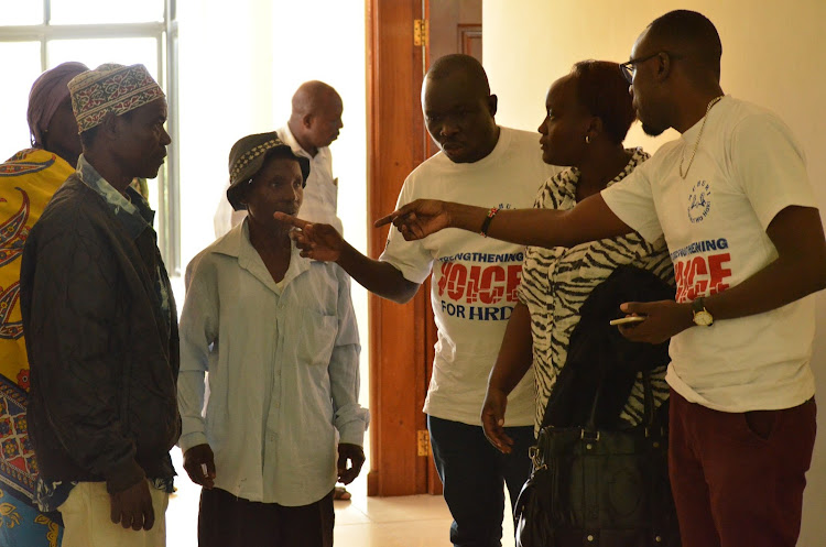 The parents of the late Katana Kazungu with Muhuri officials at Malindi High Court.