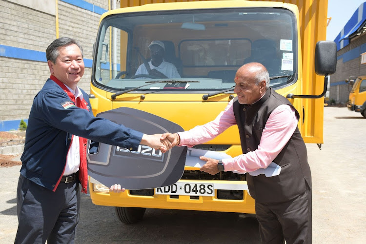 Isuzu East Africa chairman Hiroshi Hisatomi and Jumbo Steel Mills Ltd chairman Indravandan Patel during the handing over of 82 Isuzu trucks worth Sh400 million on Sunday.