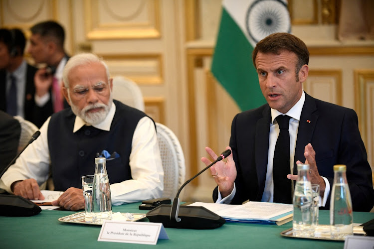 France's President Emmanuel Macron speaks as India's Prime Minister Narendra Modi.