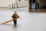 Della Parsley, a resident, helps cleaning up as evacuated mobile homes sit underwater at the Haven Acres Mobile Home Park after the San Joaquin River overflowed following rainstorms, in Lathrop, California, US March 19, 2023.  